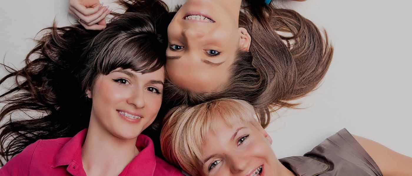 Group of teens with metal braces smiling