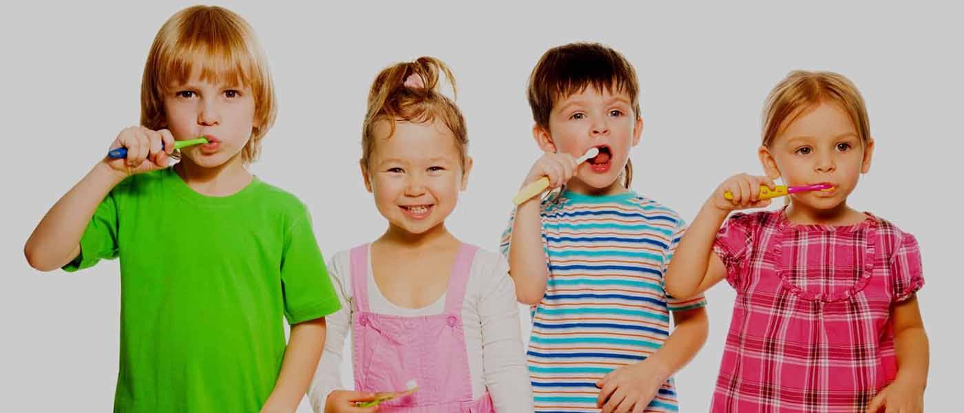 Four kids brushing teeth during super seven orthodontic checkup