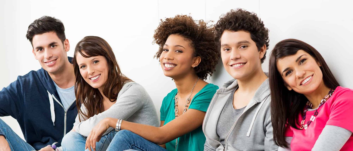 Group of smiling young people receiving Invisalign