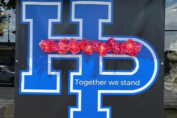 the letters hp with the phrase together we stand