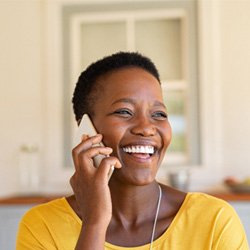 Woman in yellow shirt talking on phone