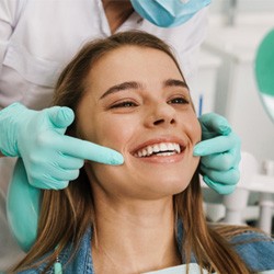Orthodontist working with smiling patient