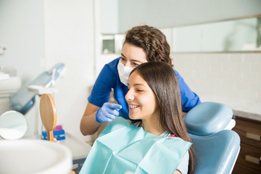 Teen smiling at the dentist with braces
