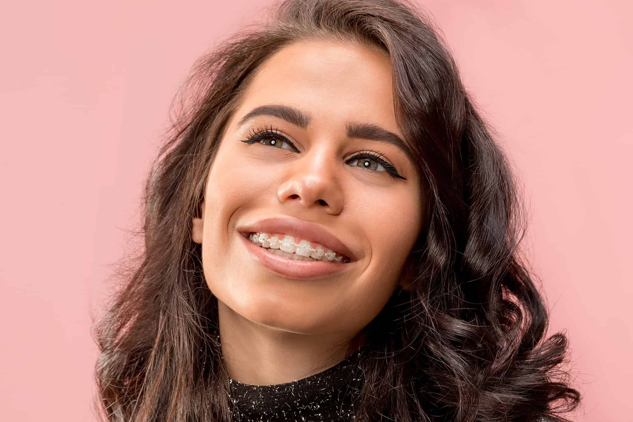 Woman smiling with a clear braces on teeth